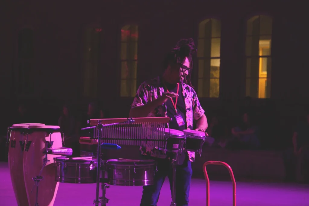 Percussionist performs during a nighttime jazz performance.