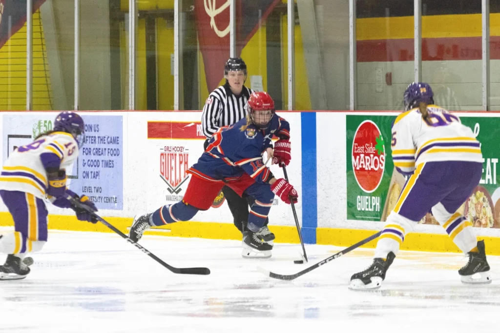 University of Guelph hockey player drives the puck forward.