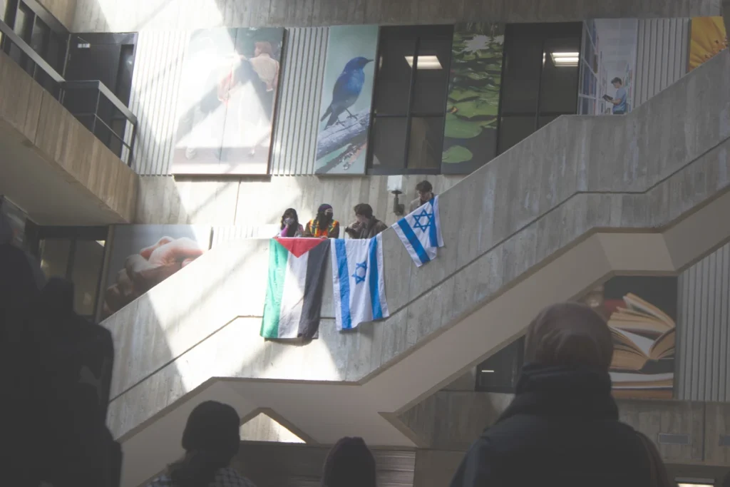 Palestinian and Israeli flags draped over a staircase railing in the University Centre Courtyard during a demonstration at the University of Guelph.
