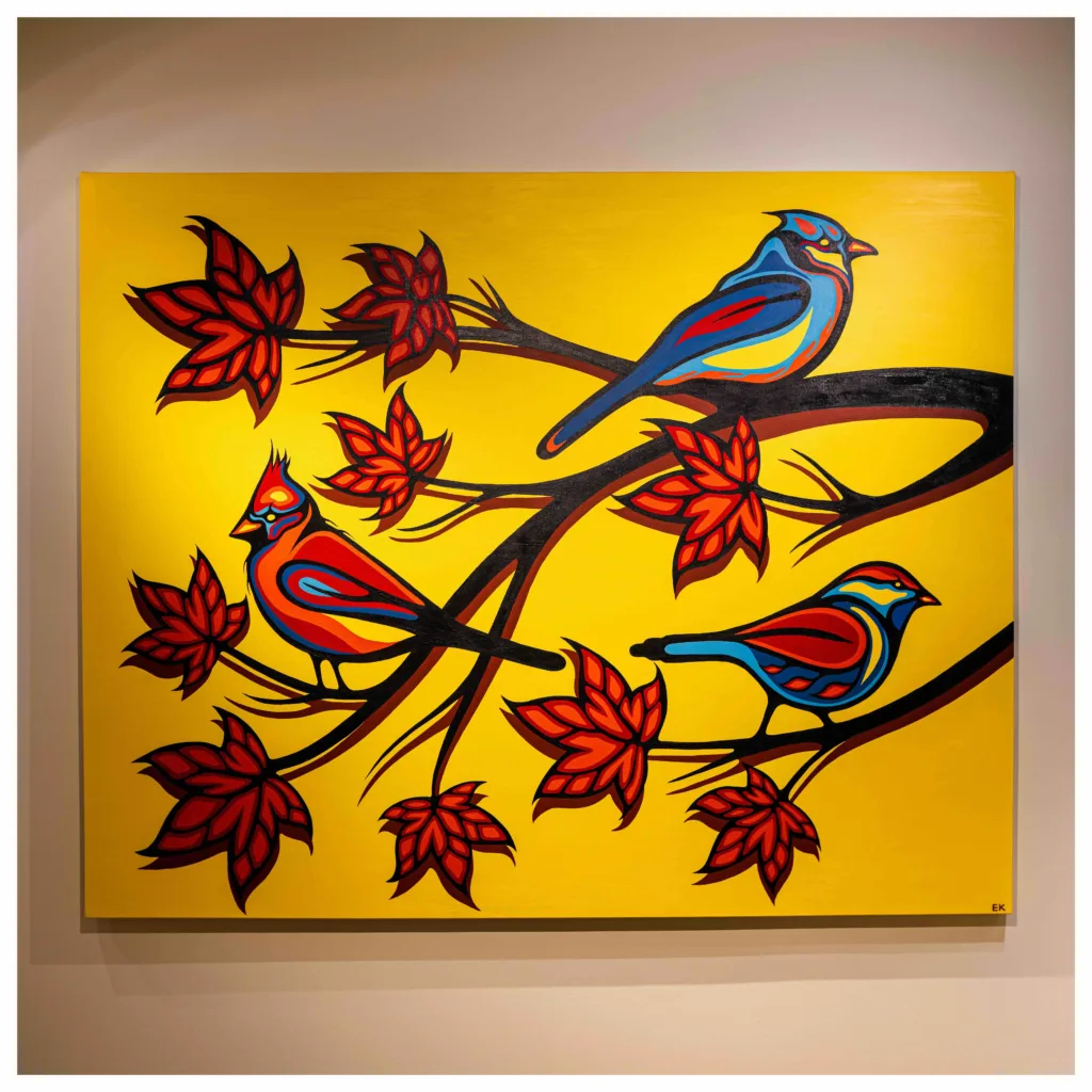 A brightly coloured painting depicts three stylized birds perched on black tree branches with red leaves against a yellow background.