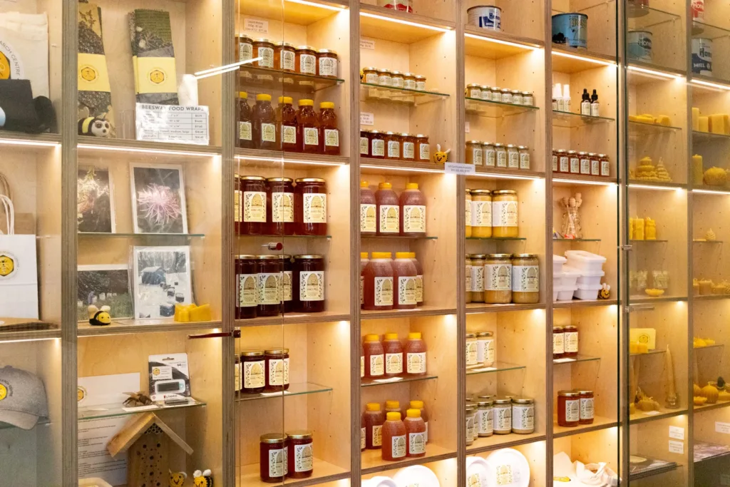 Shelves filled with jars of honey, beeswax products and beekeeping merchandise are displayed inside the Honey Bee Research Centre.